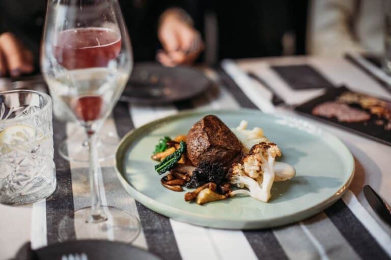 steak on table near wineglass